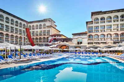a hotel with a swimming pool in front of a building at Melia Sunny Beach All Inclusive in Sunny Beach
