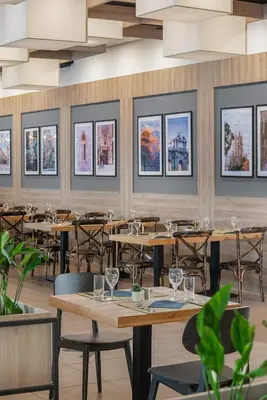 a restaurant with tables and chairs and pictures on the wall at Melia Sunny Beach All Inclusive in Sunny Beach