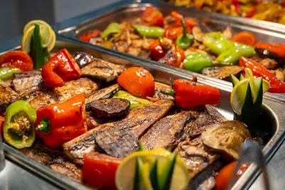 a tray of food with meat and vegetables at MPM Hotel Kalina Garden - All Inclusive in Sunny Beach