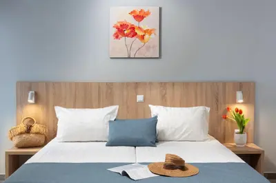 a bedroom with a bed with a hat on it at Martinez Hotel All Inclusive in Sozopol