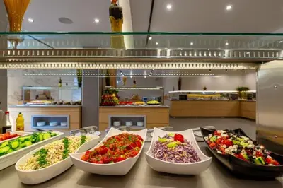 a bunch of bowls of food on a counter at Martinez Hotel All Inclusive in Sozopol