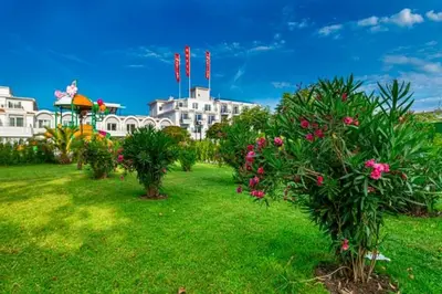 a garden with flowers and a gazebo and buildings at Martinez Hotel All Inclusive in Sozopol
