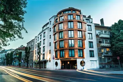 a tall building on a city street with a street at mOdus Hotel in Varna City