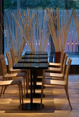 a dining table and chairs in a room at mOdus Hotel in Varna City