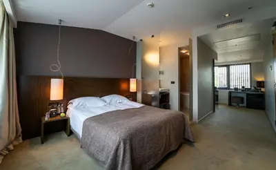 a bedroom with a large bed in a room at mOdus Hotel in Varna City