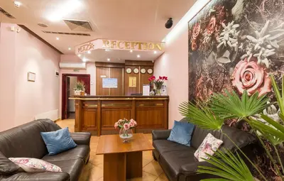 a waiting room with two leather couches and a bar at Plaza Hotel in Varna City