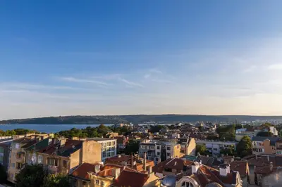 a cityscape of a city with buildings and a lake at Plaza Hotel in Varna City
