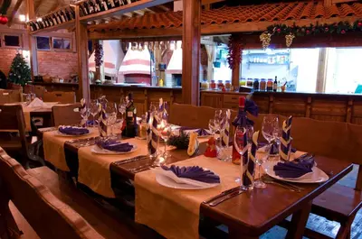 a dining room with a table with wine glasses at Aparthotel Marina Holiday Club - All Inclusive & Free Parking in Pomorie