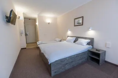 a bedroom with a large bed and a television at Hotel Azurro - All Inclusive in Sunny Beach