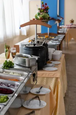 a buffet line with plates of food and glasses of wine at Hotel Azurro - All Inclusive in Sunny Beach