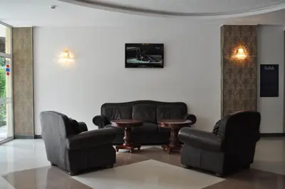 a waiting room with chairs and a couch and a table at Hotel Princess Residence in Kiten