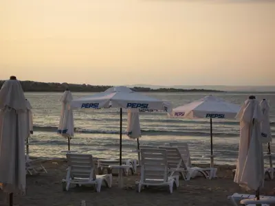 a group of chairs and umbrellas on a beach at Laguna Beach Resort & Spa in Sozopol