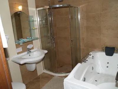 a bathroom with a shower and a sink at Laguna Beach Resort & Spa in Sozopol