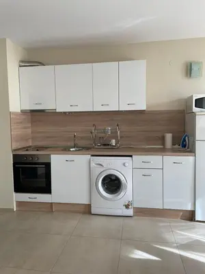a kitchen with a sink and a washing machine at Apartament Ivanovi A119 in Burgas City