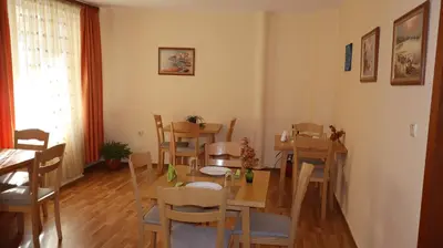 a dining room with a table and chairs at Hotel Palitra in Varna City