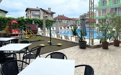 a patio with tables and chairs and a swimming pool at Hotel Onyx in Kiten