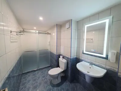 a bathroom with a toilet and a sink and a shower at Bora Bora Hotel in Sunny Beach