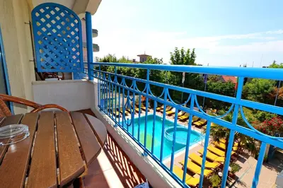 a balcony with a table and a swimming pool at Bora Bora Hotel in Sunny Beach