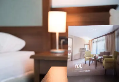 a picture of a hotel room with a living room at Lion Sunny Beach Hotel in Sunny Beach