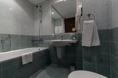 a bathroom with a sink and a tub and a toilet at Lion Sunny Beach Hotel in Sunny Beach