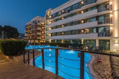 a hotel with a swimming pool in front of a building at Lion Sunny Beach Hotel in Sunny Beach
