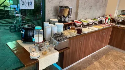 a buffet line with plates and bowls of food at Hotel L&B- Free parking in Sunny Beach