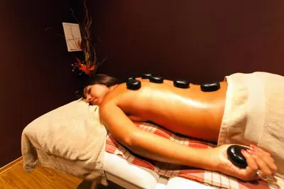 a woman laying on a bed with blackippers on her buttocks at HI Hotels Imperial Resort - Ultra All Inclusive, FREE PARKING in Sunny Beach