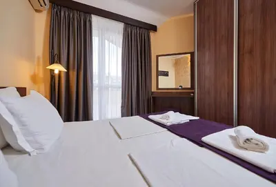 a hotel room with a bed with towels on it at Sunny Beach Hotel Forum - All Inclusive in Sunny Beach