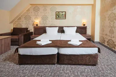 a bedroom with a large bed and a couch at Sunny Beach Hotel Forum - All Inclusive in Sunny Beach