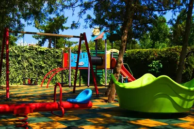 a park with a playground with a swing at Flamingo Hotel Sunny Beach in Sunny Beach