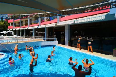 a group of people swimming in a swimming pool at Flamingo Hotel Sunny Beach in Sunny Beach