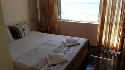 a bedroom with a bed with two towels on it at ORION Guest House in Sozopol
