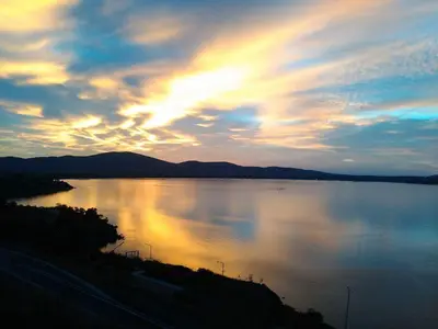 a sunset over a large body of water at ORION Guest House in Sozopol
