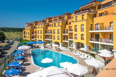 a view of a hotel with a pool and umbrellas at Serena Residence Aparthotel in Sozopol