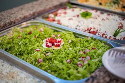 a buffet of different types of food in trays at Serena Residence Aparthotel in Sozopol
