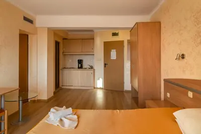 a room with a kitchen and a living room at Hotel Zeus in Pomorie