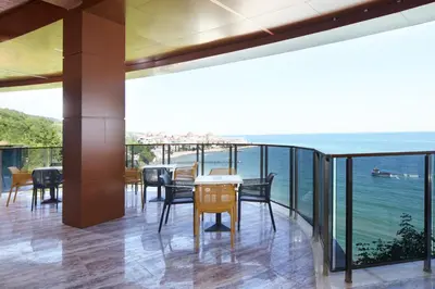 a dining room with a view of the ocean at Paradise Beach Residence - Ultra All Inclusive in Sveti Vlas