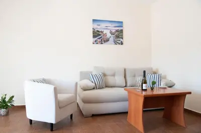 a living room with a couch and a table at Семеен хотел Амон Ра in Sozopol