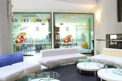 a store with couches and tables in front of a window at Smartline Meridian Hotel in Sunny Beach