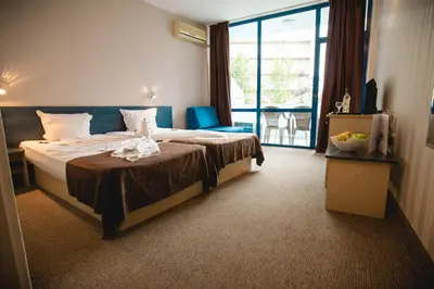 a hotel room with a bed and a large window at Hotel Bohemi in Sunny Beach