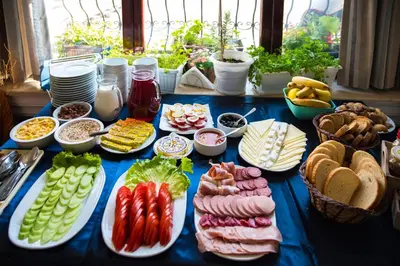 a table filled with different types of food on plates at Victoria Hotel Nessebar in Nesebar
