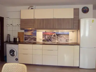 a kitchen with white cabinets and a white refrigerator at Apartment Tourist Complex Rose Village in Sunny Beach