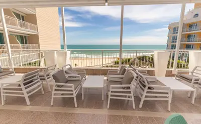 a patio with chairs and tables and a view of the ocean at Bilyana Beach Hotel- Adults only in Nesebar