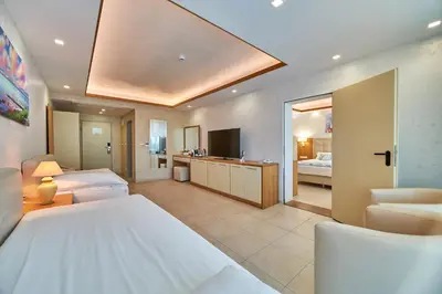 a large bedroom with a bed and a bathroom at Bilyana Beach Hotel- Adults only in Nesebar