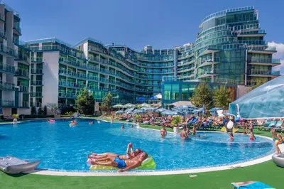 a large swimming pool with many people in it at Hotel Primorsko Del Sol in Primorsko