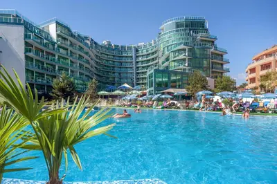 a large swimming pool with people in a resort at Hotel Primorsko Del Sol in Primorsko