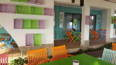 a restaurant with colorful chairs and a table at Marina Cape Vacation Complex in Ravda