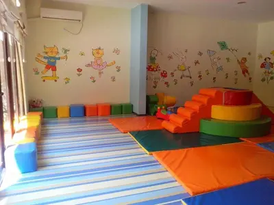 a childs room with colorful floors and a play area at Marina Cape Vacation Complex in Ravda