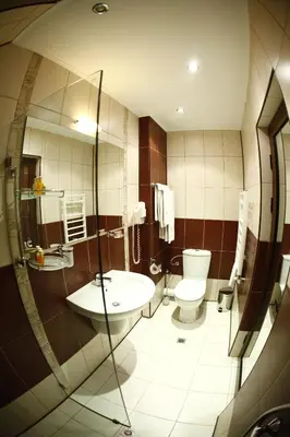 a bathroom with a sink and a toilet and a mirror at Hi Boutique Hotel in Varna City