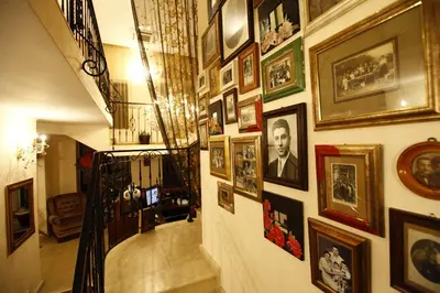 a hallway with a bunch of pictures on a wall at Hi Boutique Hotel in Varna City